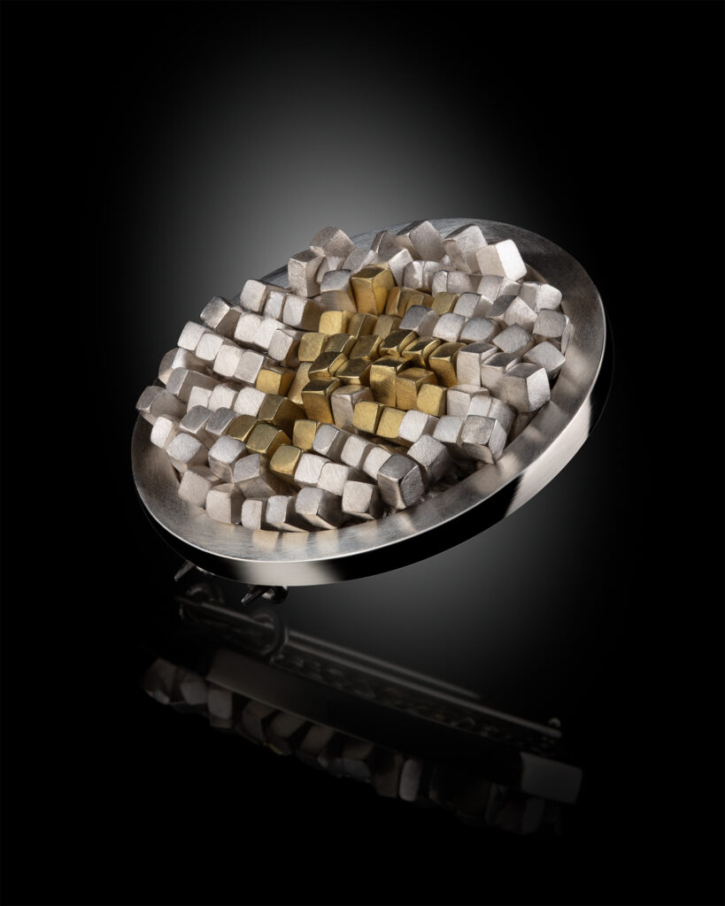 Jewellery photography. Silver and gold brooch.